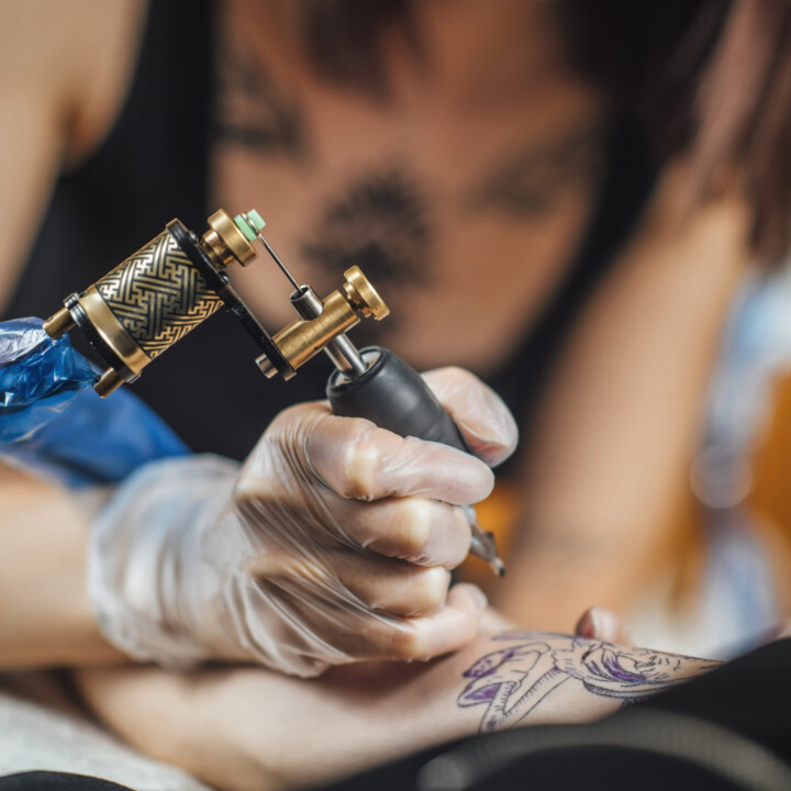 tattoo-machine-close-up-tattoo-artist-creating-tat